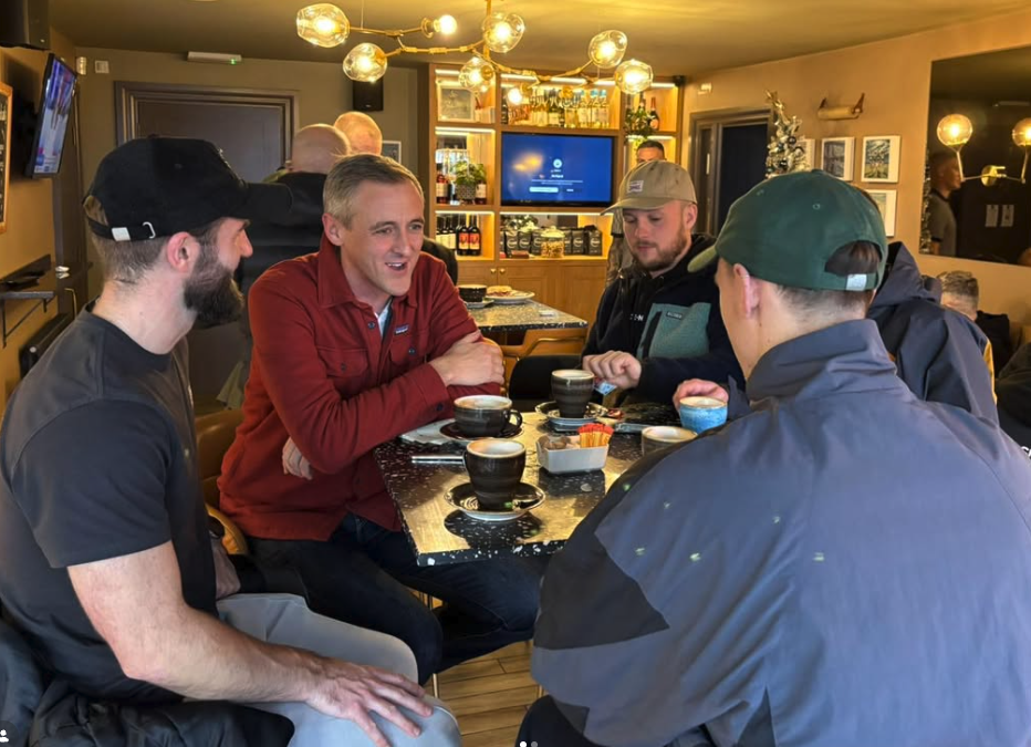 Four men in a group talking