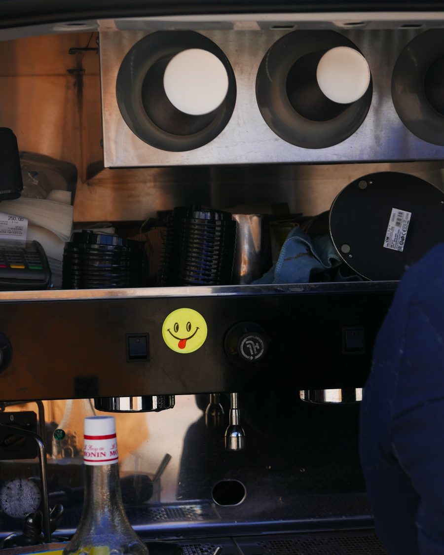 Inside the Space coffee van, a smiley sticker on the espresso machine